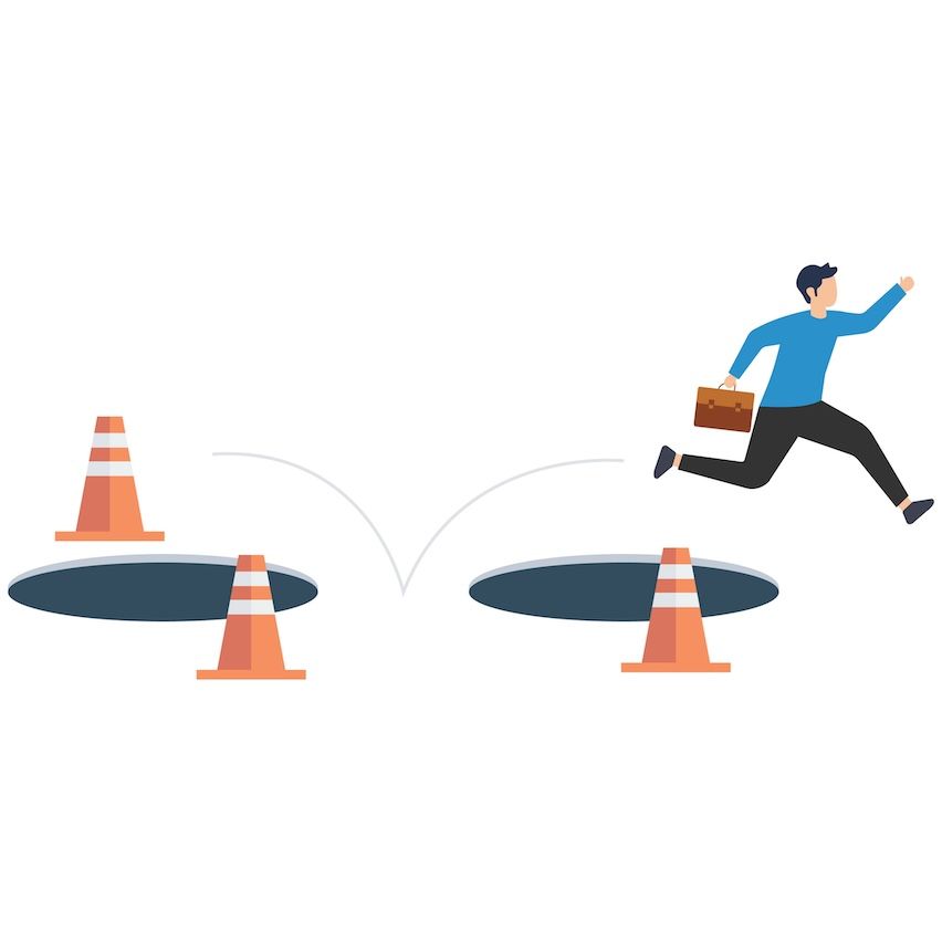 Businessman leaping over pitfalls marked by cones, symbolizing avoiding email marketing mistakes.