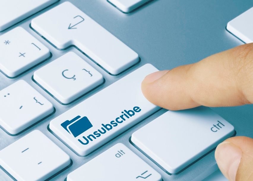 Keyboard with a large 'Unsubscribe' button being pressed, symbolizing email opt-out compliance.