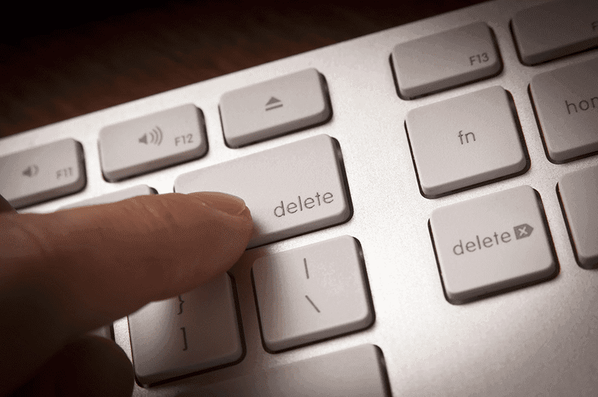 Finger pressing the delete button on a keyboard to remove unresponsive subscribers from a list.