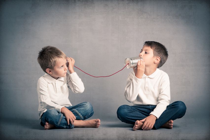 Two boys using tin cans and string to talk, illustrating a steady communication flow with email automation.