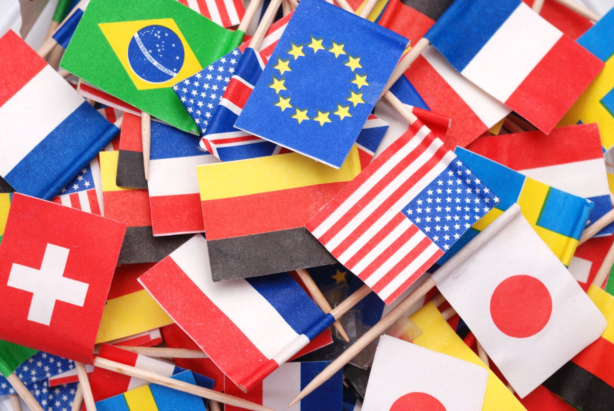 Small flags from various countries representing global audiences and international email marketing.