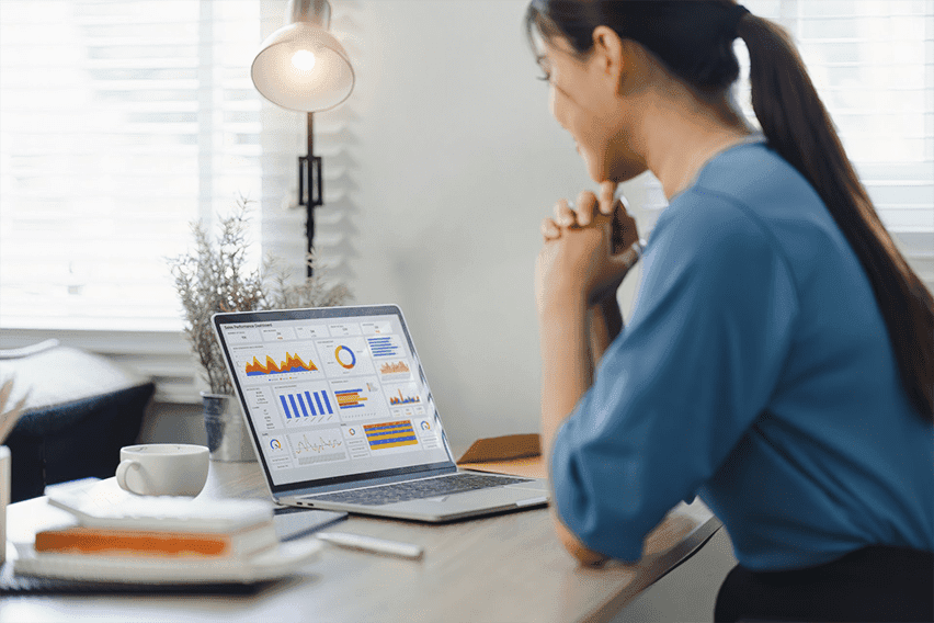 Young woman analyzing email campaign metrics on her laptop for effective list management.