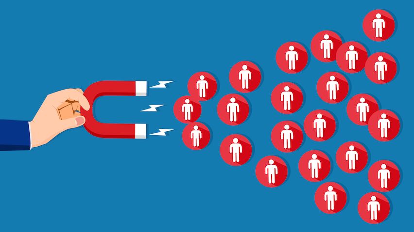 Hand with magnet attracting icons with figures, symbolizing lead nurturing through email courses.