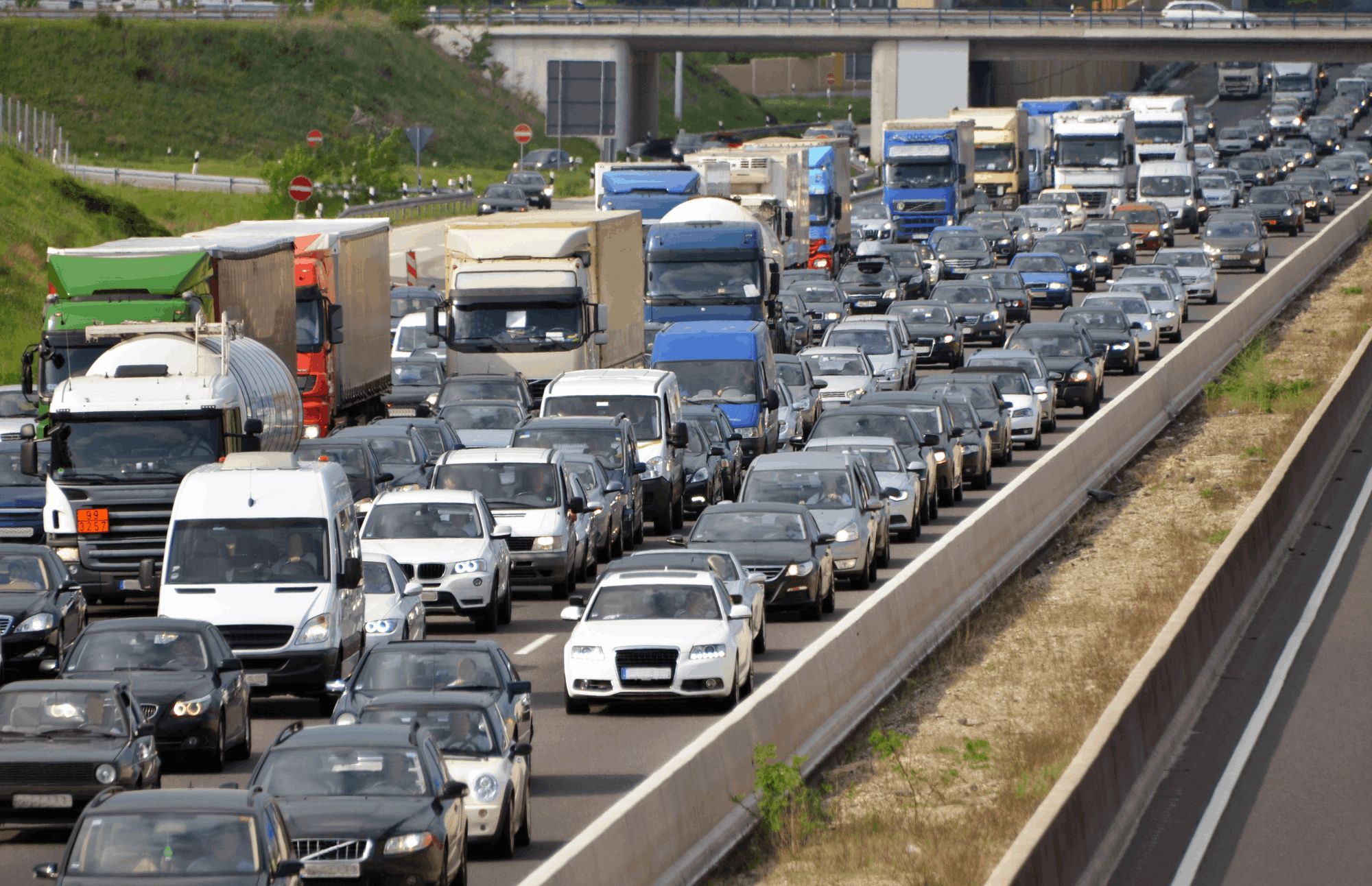 Heavy highway traffic during rush hour, symbolizing the congestion caused by sending emails at peak times.