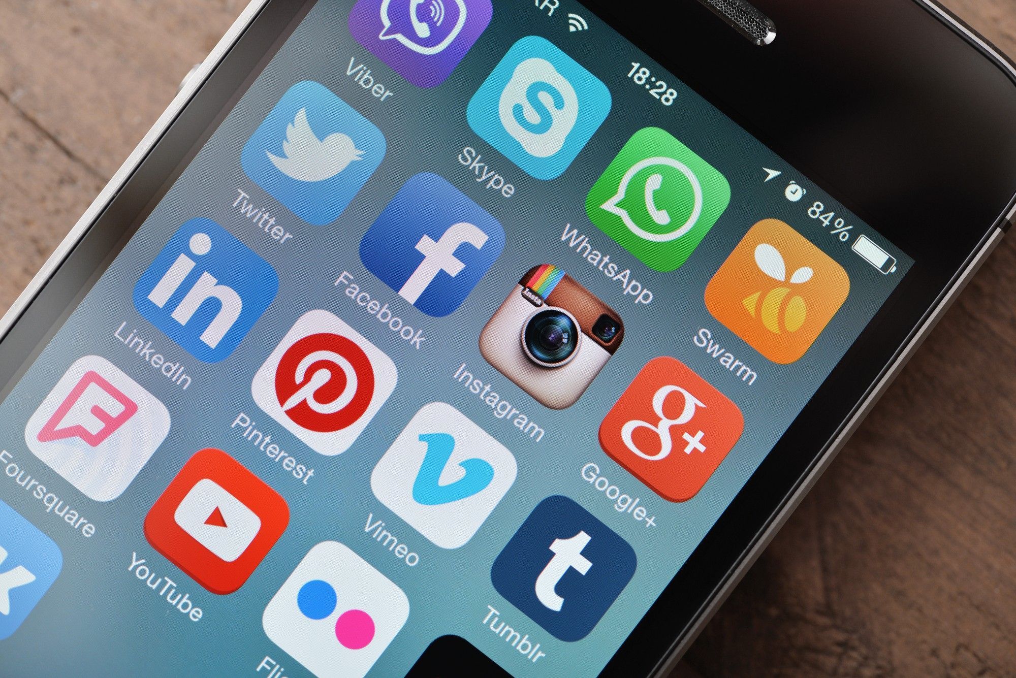 Smartphone screen showing social media app icons, representing low-cost marketing strategies for startups.