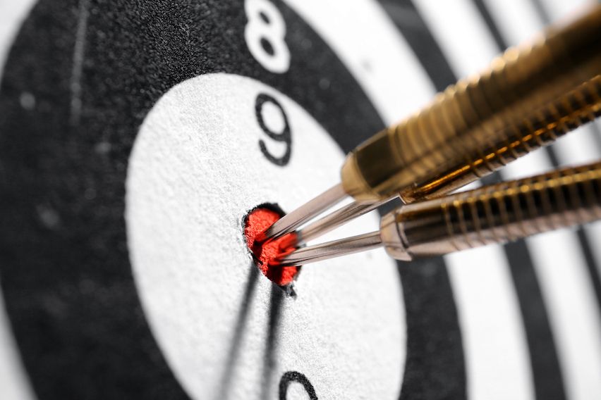 Three darts hitting the bullseye on a dartboard, representing precise, targeted communication in email marketing.